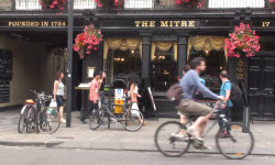 Students walk past a pub